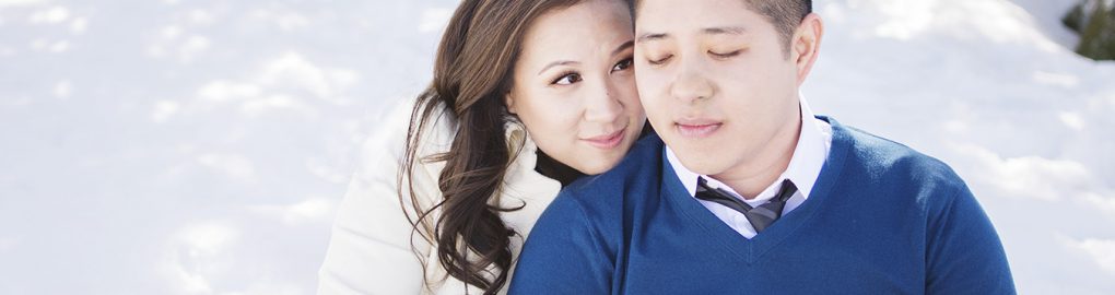 Engaged couple snuggling in the snow on the Grand Mesa