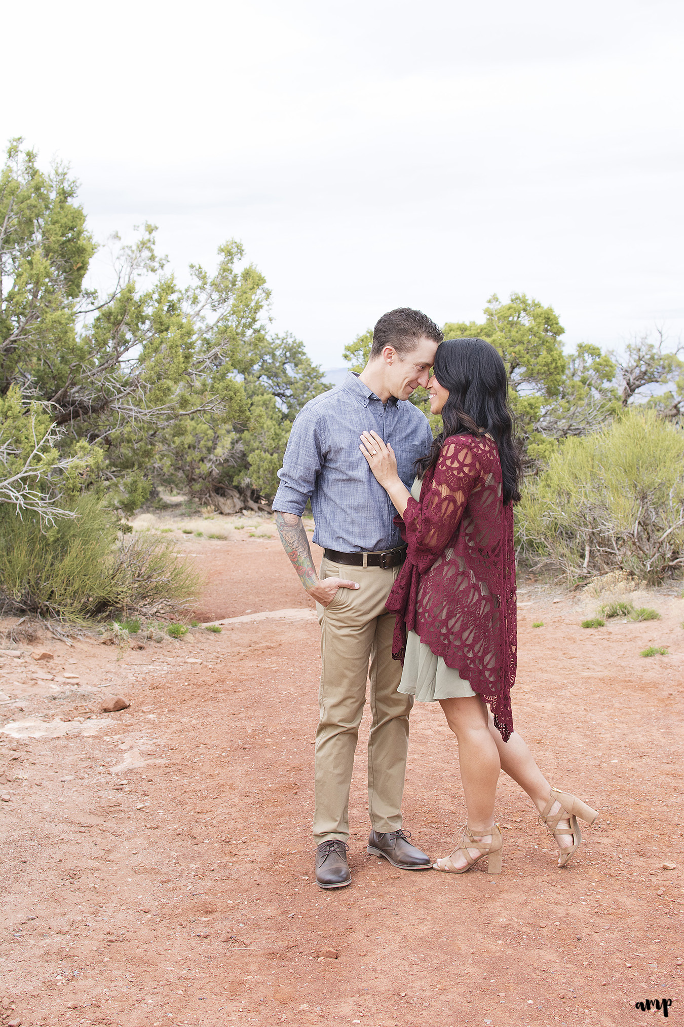 Couple sharing a quiet moment during their desert engagement photos