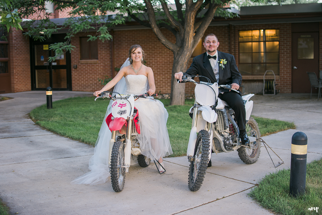 Bride and groom riding dirt bikes