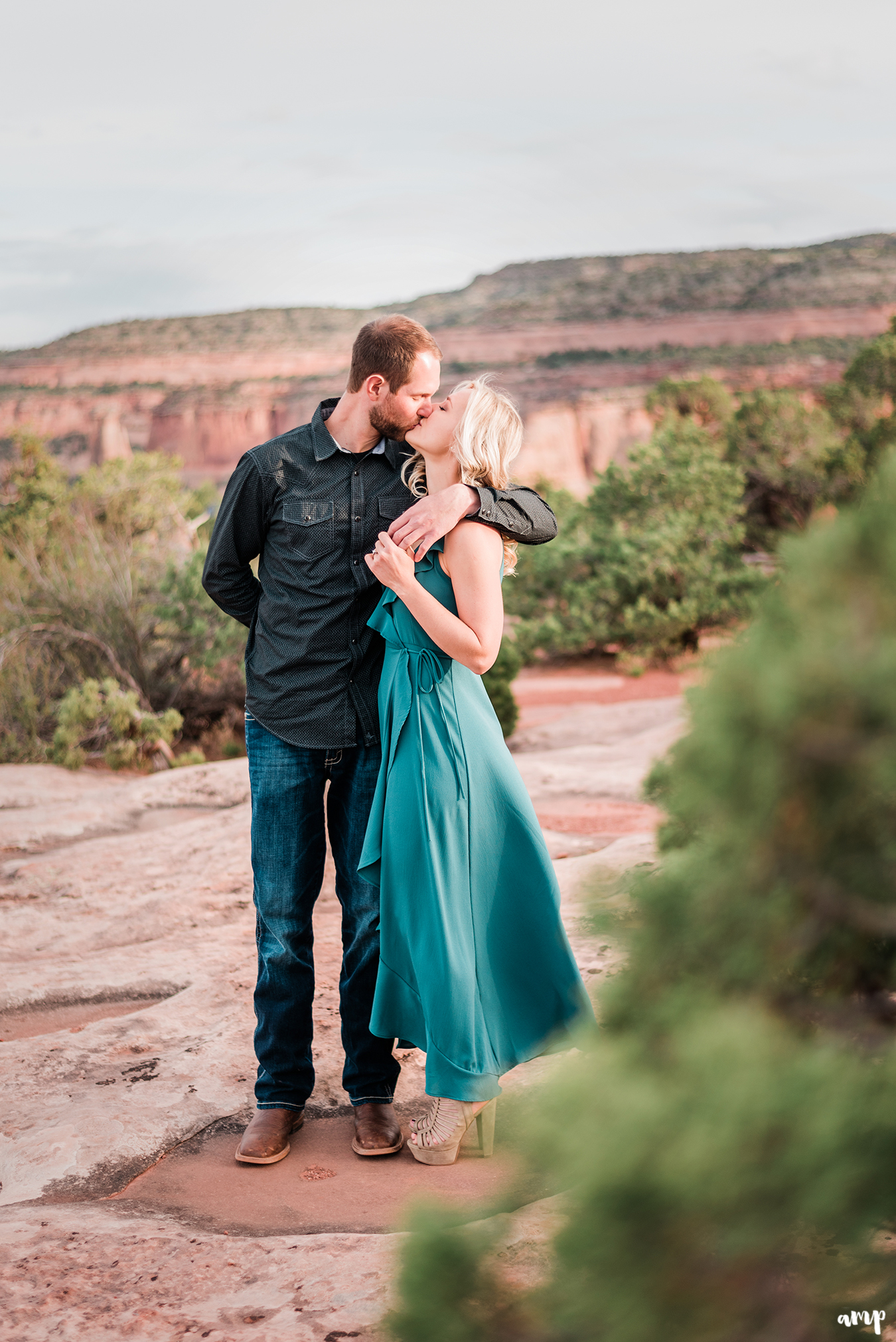 Dylan and Lexi share a kiss on the Colorado National Monument for their engagement photos