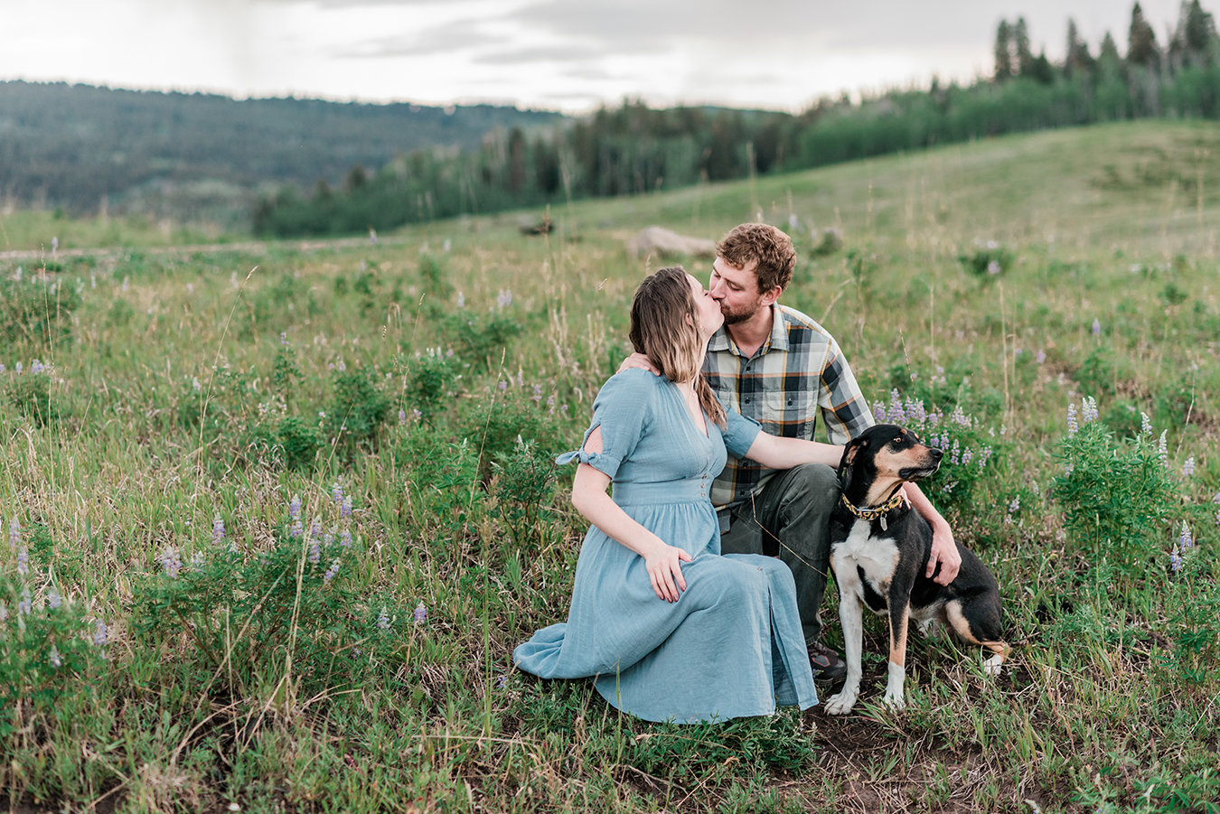 Annie & Taylor's dog looks away while the two kiss during their Glenwood Springs engagement photos